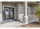 Front porch features a double door entry, decorative columns, and concrete flooring at 24429 Adair Ave, Sorrento, FL 32776