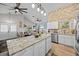 Open-concept kitchen with stainless steel appliances and a stone accent wall at 24429 Adair Ave, Sorrento, FL 32776