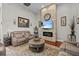 Inviting living room with stone accent wall, fireplace, TV, and neutral decor at 24429 Adair Ave, Sorrento, FL 32776