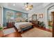 Serene main bedroom featuring a tray ceiling, natural light, and a warm color palette promotes rest and relaxation at 24429 Adair Ave, Sorrento, FL 32776