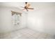 Simple bedroom with ceiling fan and window at 25324 Hibiscus St, Leesburg, FL 34748