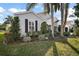 House exterior with light siding, black shutters, and landscaping at 25324 Hibiscus St, Leesburg, FL 34748