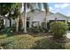 One-story house with light siding, dark green door and landscaping at 25324 Hibiscus St, Leesburg, FL 34748