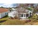 Rear view of a house with a screened patio and yard at 25324 Hibiscus St, Leesburg, FL 34748