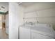 Laundry room with washer, dryer, and shelving at 25324 Hibiscus St, Leesburg, FL 34748