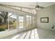 Bright sunroom with tile flooring, ceiling fan, and screened windows at 25324 Hibiscus St, Leesburg, FL 34748