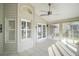 Sunroom with tile flooring, ceiling fan and French doors at 25324 Hibiscus St, Leesburg, FL 34748