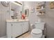 Clean bathroom with white cabinets, neutral-toned walls, and a large mirror at 25547 Belle Helene, Leesburg, FL 34748