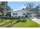 Single-story home with carport and lush lawn at 25547 Belle Helene, Leesburg, FL 34748