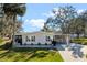 Single-story home with carport and landscaped lawn at 25547 Belle Helene, Leesburg, FL 34748