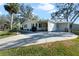 Mobile home with carport and landscaped yard at 25547 Belle Helene, Leesburg, FL 34748