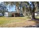 Single story home with covered porch and lush lawn at 25547 Belle Helene, Leesburg, FL 34748