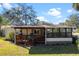 Single story home with covered porch and lush lawn at 25547 Belle Helene, Leesburg, FL 34748