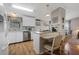 Bright kitchen with white cabinetry, modern appliances, and breakfast bar seating at 25547 Belle Helene, Leesburg, FL 34748
