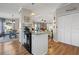 Open concept kitchen with island and breakfast bar, seamlessly flowing into the living area at 25547 Belle Helene, Leesburg, FL 34748