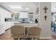 Bright kitchen with white cabinetry, modern appliances, and breakfast bar seating at 25547 Belle Helene, Leesburg, FL 34748