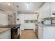 Modern kitchen featuring white cabinets, granite countertops, and stainless steel appliances at 25547 Belle Helene, Leesburg, FL 34748