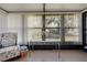 Bright sunroom featuring tile floors, large windows with vertical blinds and a view of the landscaped front yard at 25547 Belle Helene, Leesburg, FL 34748
