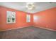 Spacious bedroom with neutral carpeting and coral walls at 27008 Camerons Run, Leesburg, FL 34748