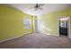 Well-lit bedroom with neutral carpeting and a ceiling fan at 27008 Camerons Run, Leesburg, FL 34748