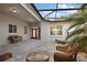 Inviting courtyard entry with brick pavers, wicker furniture, and a glass-top table at 27008 Camerons Run, Leesburg, FL 34748