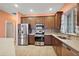 Modern kitchen with stainless steel appliances and wood cabinets at 27008 Camerons Run, Leesburg, FL 34748