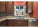 Kitchen features a double sink with modern faucet and tile backsplash at 27008 Camerons Run, Leesburg, FL 34748