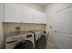 Laundry room with Samsung washer and dryer and upper cabinets at 27008 Camerons Run, Leesburg, FL 34748