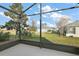 Screened patio with view of backyard and neighboring homes at 27008 Camerons Run, Leesburg, FL 34748