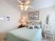 Bedroom with a queen bed, ceiling fan, and artwork on the wall at 2849 Leicester Ter, The Villages, FL 32162