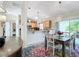 Bright dining area with colorful rug and kitchen view at 2849 Leicester Ter, The Villages, FL 32162