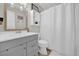 Clean bathroom with a vanity, toilet, and shower/tub at 307 Park Ave, Groveland, FL 34736