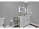 Modern bathroom with a white vanity and sleek mirror at 307 Park Ave, Groveland, FL 34736