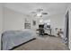 Neutral bedroom featuring carpeted floors, a ceiling fan, and a desk area at 307 Park Ave, Groveland, FL 34736