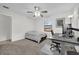 Neutral bedroom featuring carpeted floors, a ceiling fan, and a desk area at 307 Park Ave, Groveland, FL 34736