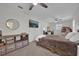 Bedroom featuring a TV, ceiling fan, and comfortable wicker chair at 307 Park Ave, Groveland, FL 34736