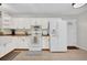 Bright kitchen featuring white cabinets, butcher block countertops, and stainless appliances at 307 Park Ave, Groveland, FL 34736