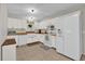 White kitchen with farm sink, wood countertops, and stainless steel appliances at 307 Park Ave, Groveland, FL 34736