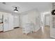 Open kitchen and dining area featuring neutral tiling and white appliances at 307 Park Ave, Groveland, FL 34736