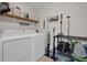 Laundry room with washer, dryer, and ample storage shelving at 307 Park Ave, Groveland, FL 34736