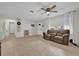 Inviting living room with a neutral color palette, ceiling fan, and ample natural light at 307 Park Ave, Groveland, FL 34736