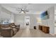 Comfortable living room showcasing a ceiling fan, neutral paint, and a media center at 307 Park Ave, Groveland, FL 34736