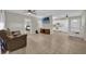 Open concept living space featuring tile floors, a flat screen tv, and a modern kitchen at 307 Park Ave, Groveland, FL 34736