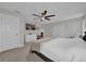 Carpeted bedroom with a modern ceiling fan, neutral decor, and a view to living space at 307 Park Ave, Groveland, FL 34736