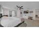 Comfortable bedroom featuring soft carpeting, a ceiling fan, and a view to ensuite bathroom at 307 Park Ave, Groveland, FL 34736