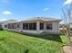 Well-maintained backyard featuring a screened-in lanai and lush green lawn at 3183 Hatch Ln, The Villages, FL 32162