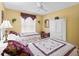 Charming bedroom featuring twin beds, yellow walls, and a large decorative wardrobe at 3183 Hatch Ln, The Villages, FL 32162