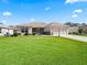 A well maintained single-story home featuring an attached two-car garage and a lush green lawn at 3183 Hatch Ln, The Villages, FL 32162