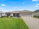 Charming single-story home with a well-manicured lawn and neutral exterior at 3183 Hatch Ln, The Villages, FL 32162