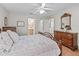 Relaxing primary bedroom features wood-look floors, ensuite bathroom, and walk-in closet access at 3183 Hatch Ln, The Villages, FL 32162